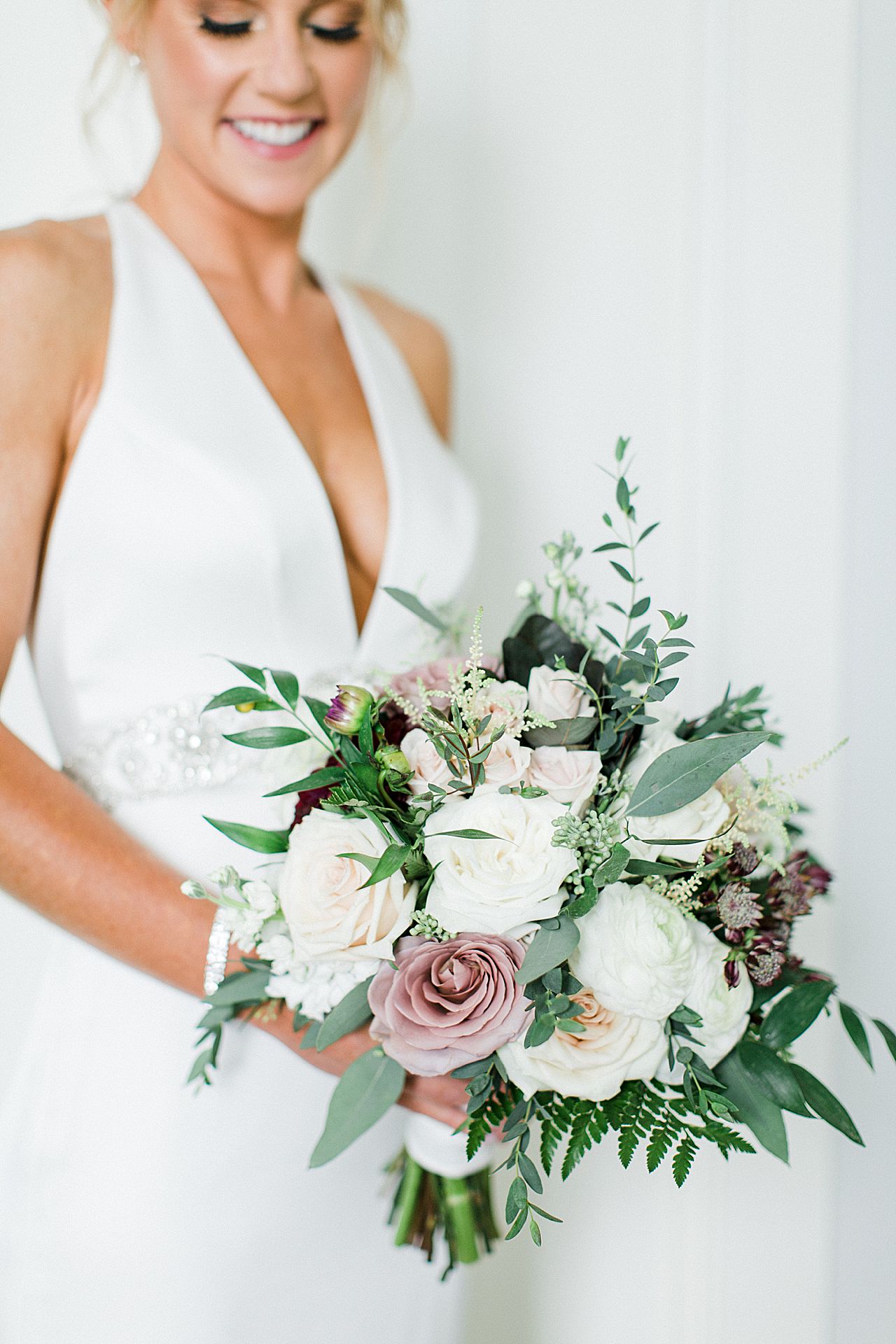 A brides bouquet with pinks, whites, and purples