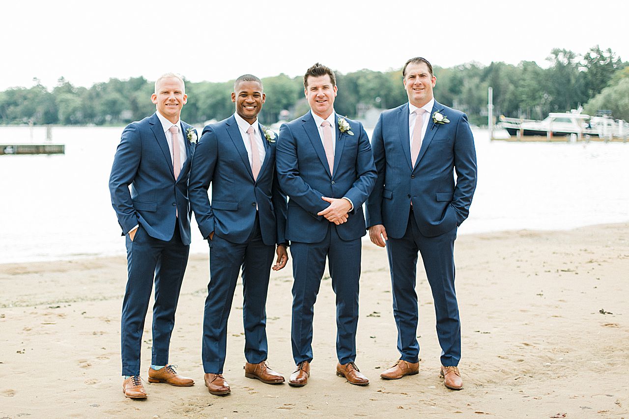 A groom and groomsmen by the water in Harbor Springs, Michigan