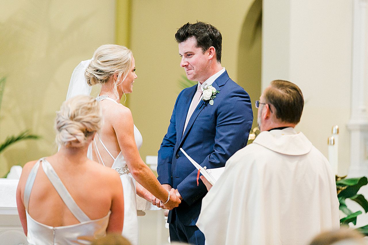 A bride and groom stating their vows ate their wedding ceremony at Holy Childhood of Jesus Catholic Church in Harbor Springs, Michigan