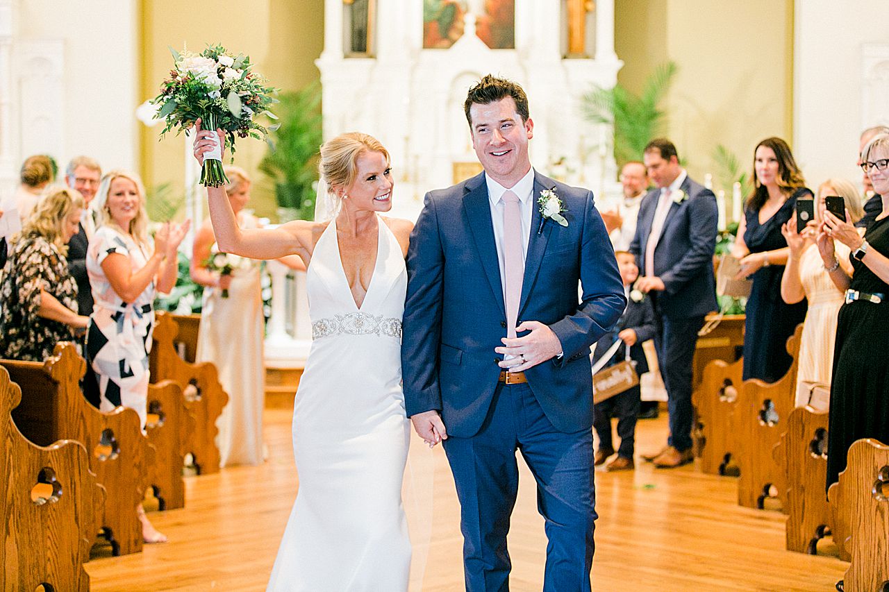 A bride and groom walking down the aisle after their first kiss in Harbor Springs, Michigan