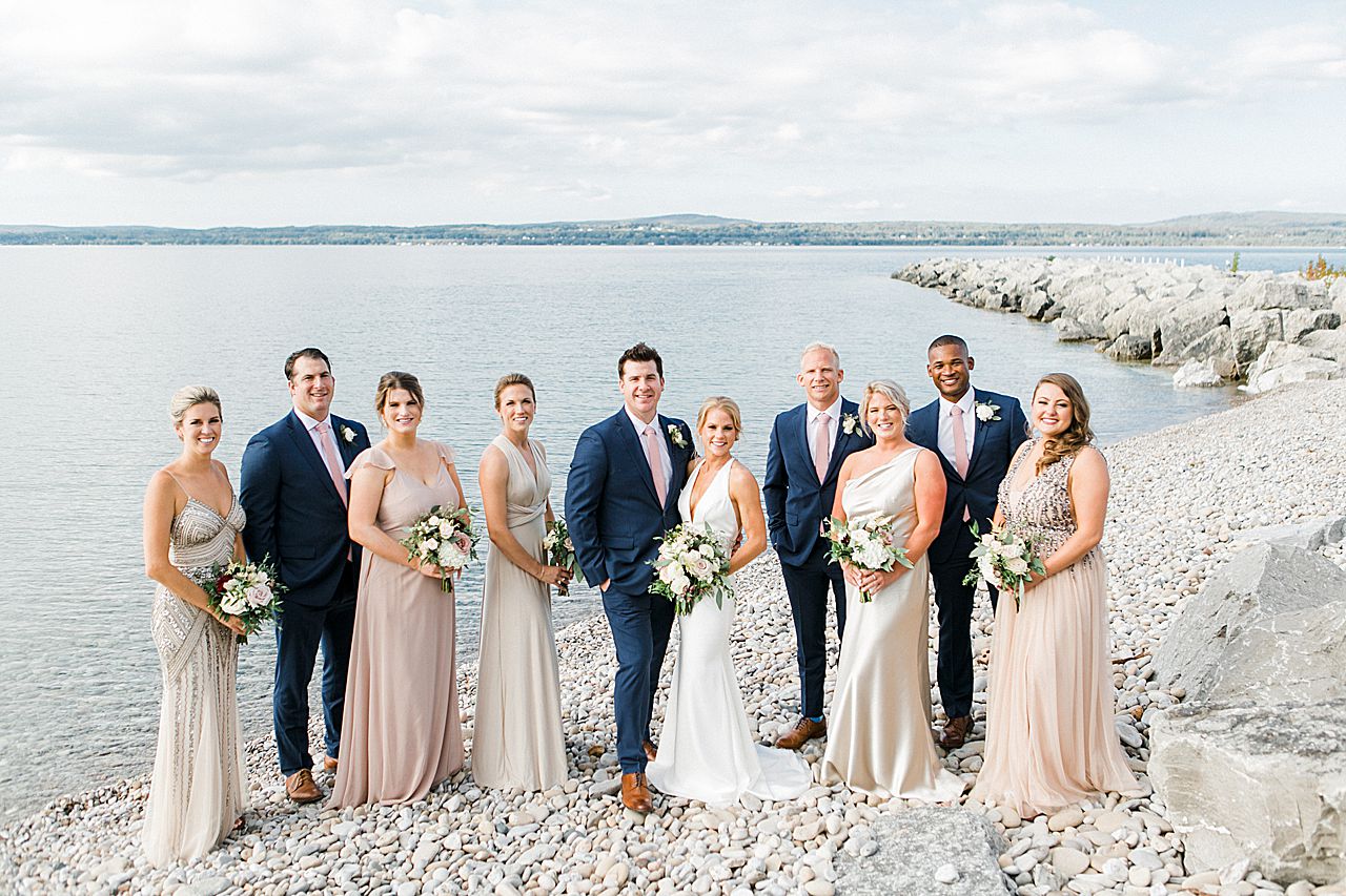 A bridal party portrait on little traverse bay in Petoskey, Michigan