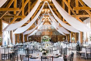 A wedding reception inside of Shanahan's Barn in Charlevoix, Michigan with draping