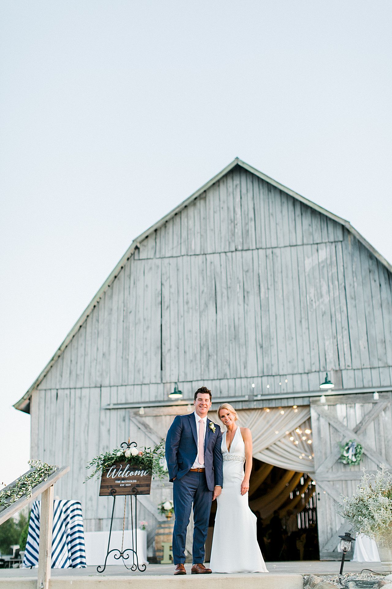 A bride and groom taking portraits with Shanahan's Barn in the background