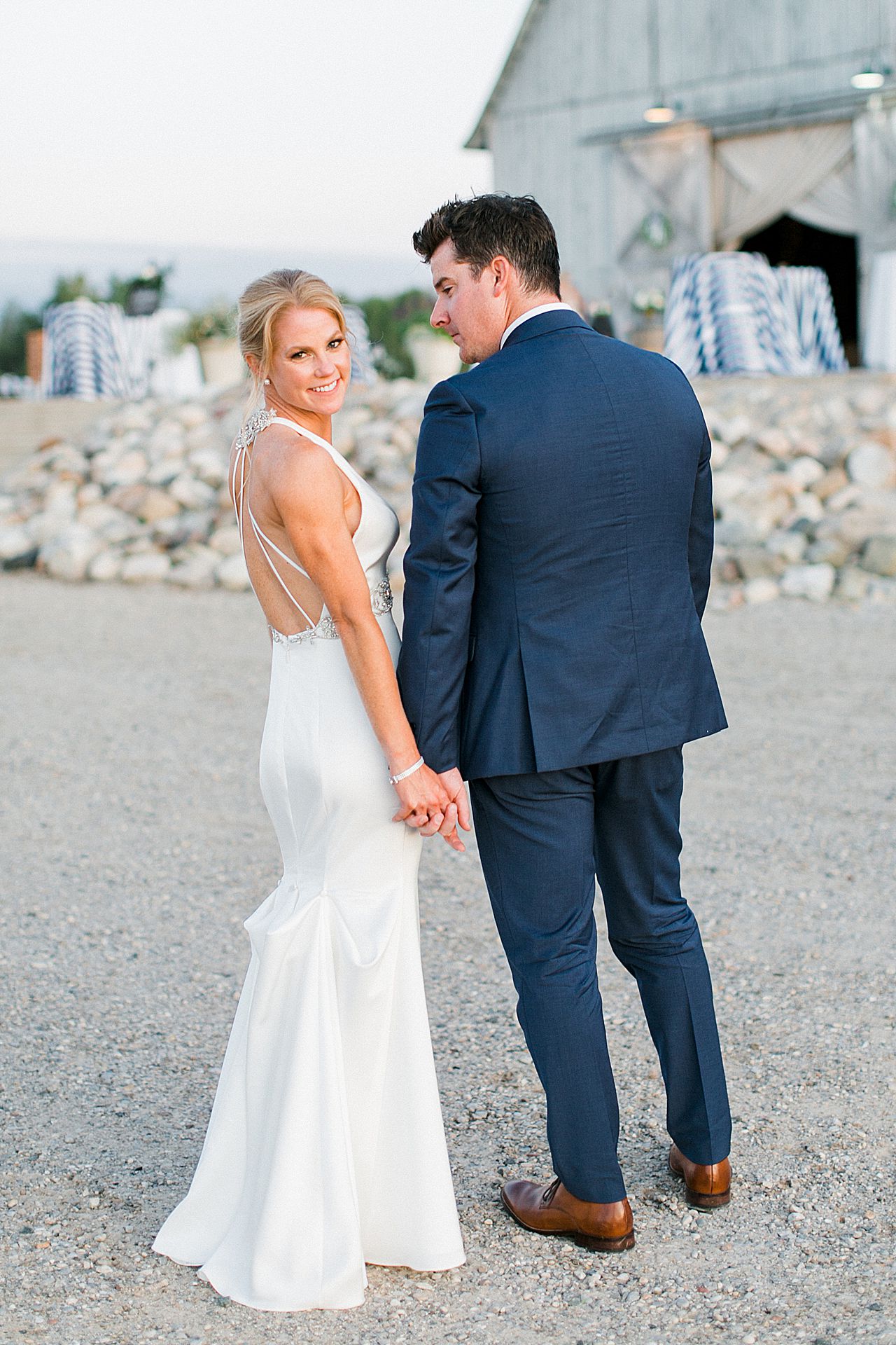 A bride and groom taking portraits with Shanahan's Barn in the background