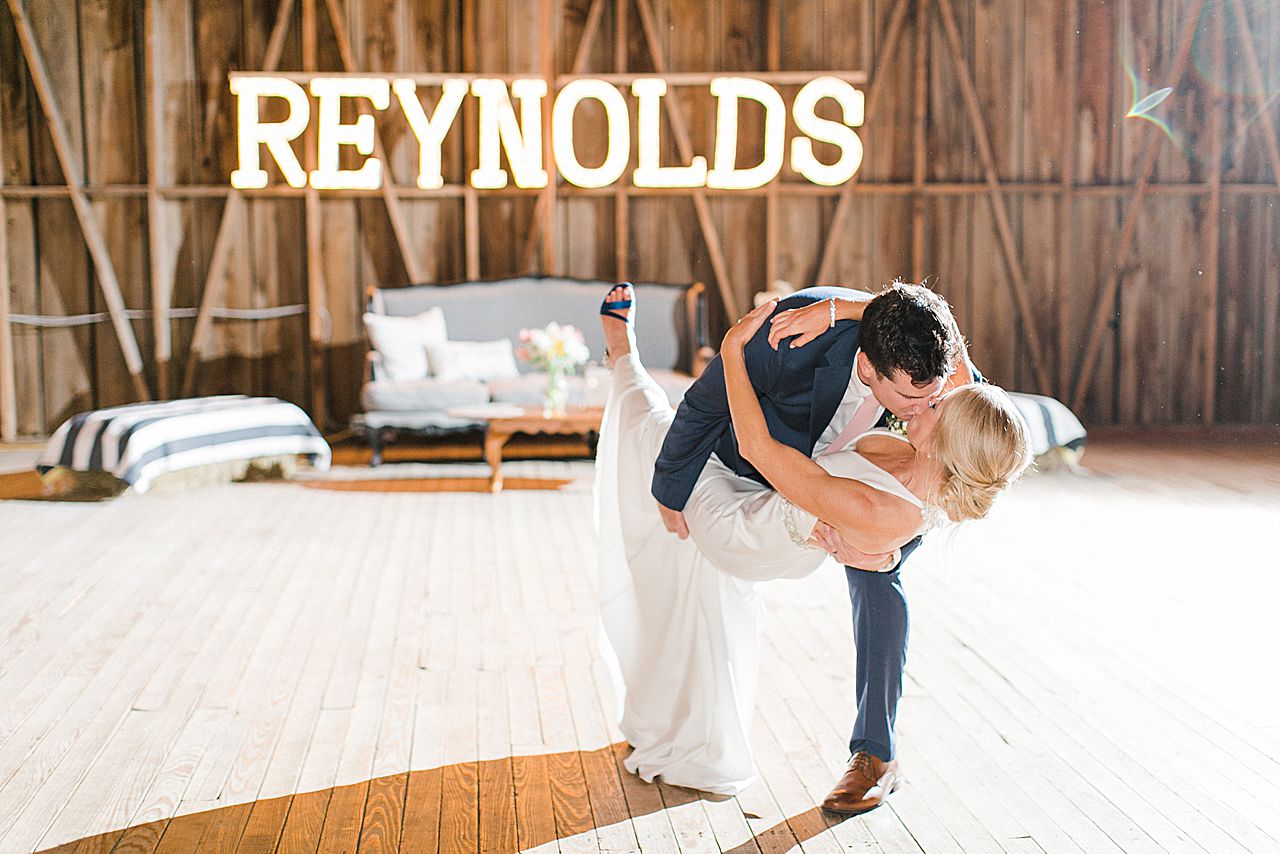 A bride and groom having their first dance in Shanahan's Barn in Charlevoix, Michigan