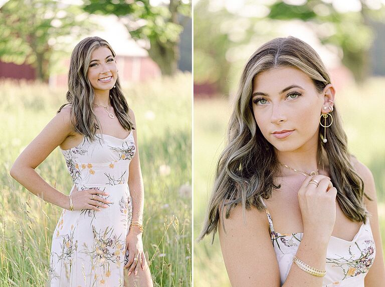 A high school senior girl taking portraits in a grassy field with a white dress with flowers on it in Charlevoix, Michigan