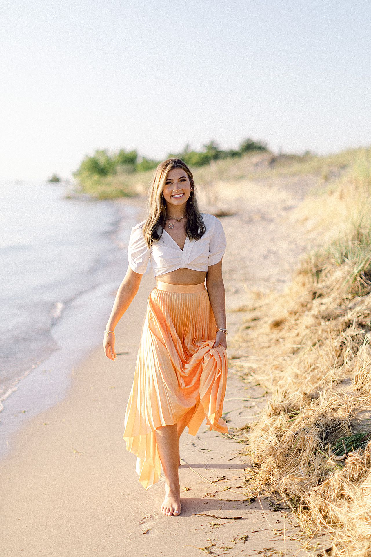 A high school senior walking along the shoreline in Northern Michigan