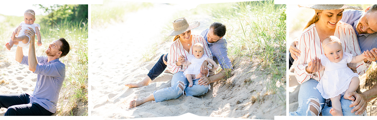 A family of 3 sitting in the sand near dune grass in Northern Michigan