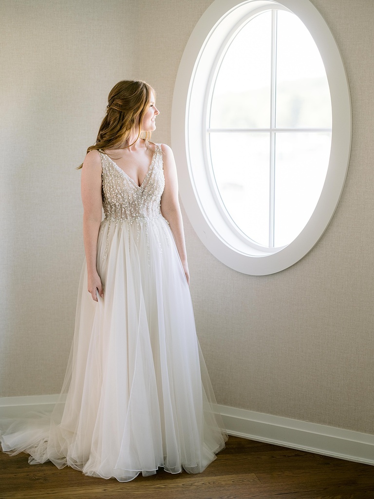 A bride looking out of a window in Northern Michigan.