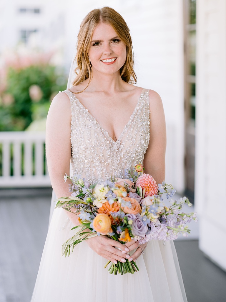 Portrait of a bride with bouquet on a porch at Hotel Walloon.