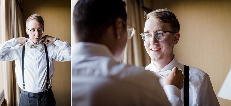 A groom getting ready on his wedding day while a groomsmen helps.