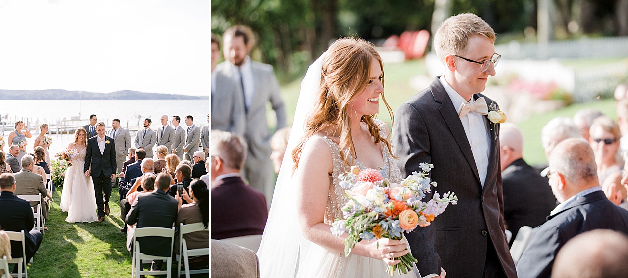 A bride and groom smiling as they walk down a grassy aisle as a newly married couple.