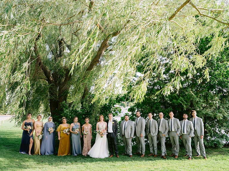 A bridal party portrait in the shade of a willow tree in Walloon, Michigan in the summer.