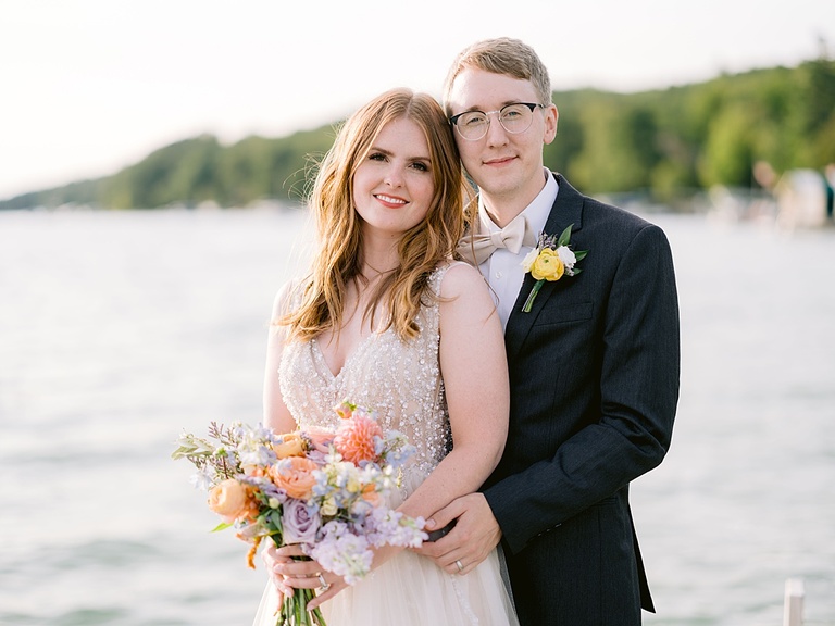 Portrait of a bride and groom during the golden hour with a Michigan lake in the background.