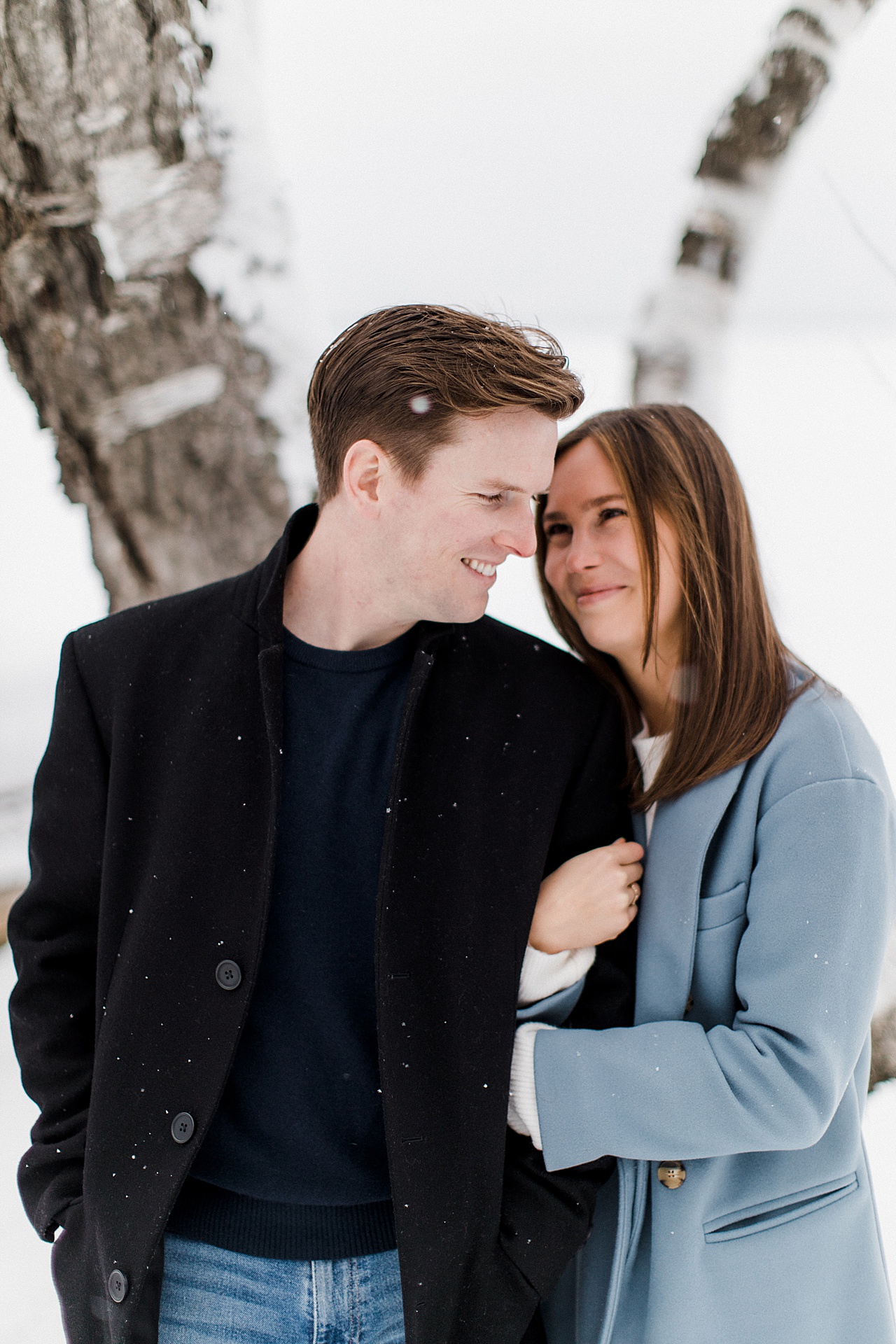 A couple taking engagement photos in Cheboygan, Michigan