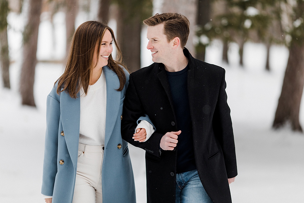 A couple walking and smiling at each other in Cheboygan, Michigan
