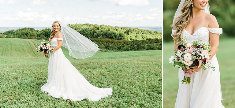 A bride taking portraits on a grassy bluff overlooking Lake Michigan