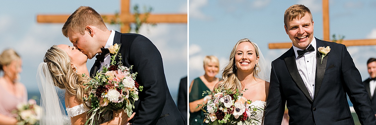 A bride and groom smiling and kissing as they walk dow the aisle as husband and wife in Northern Michigan