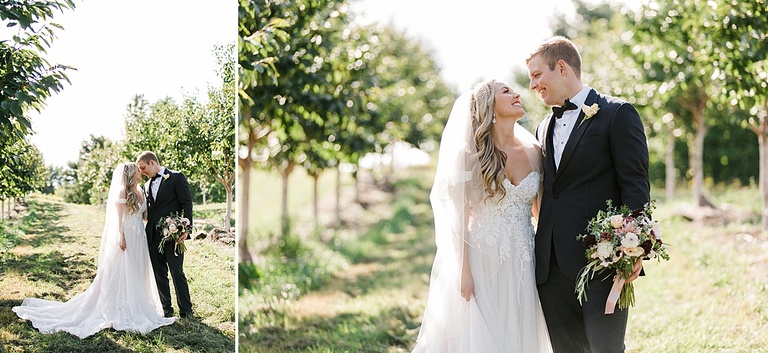 A bride and groom taking portraits in an orchard