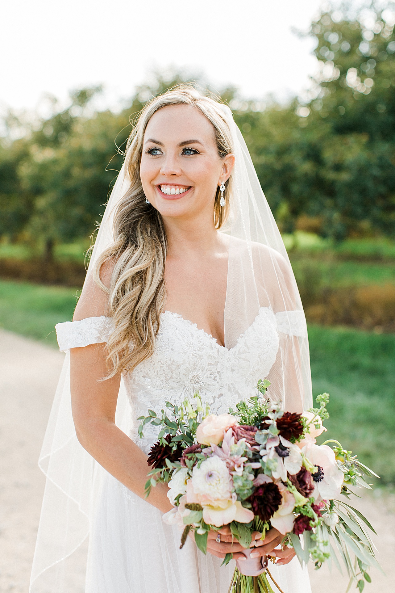 A bride smiling while looking at her husband