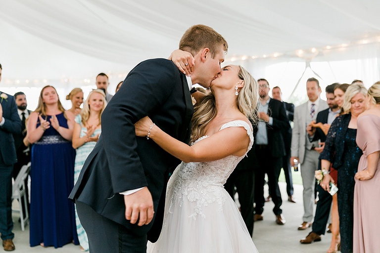 A bride and groom kissing after their first dance