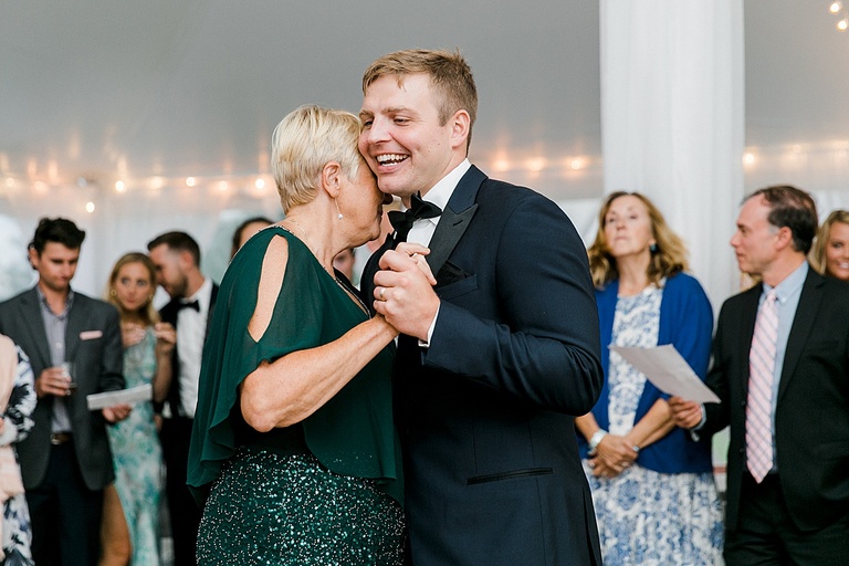 A groom dancing with his mother at a wedding reception