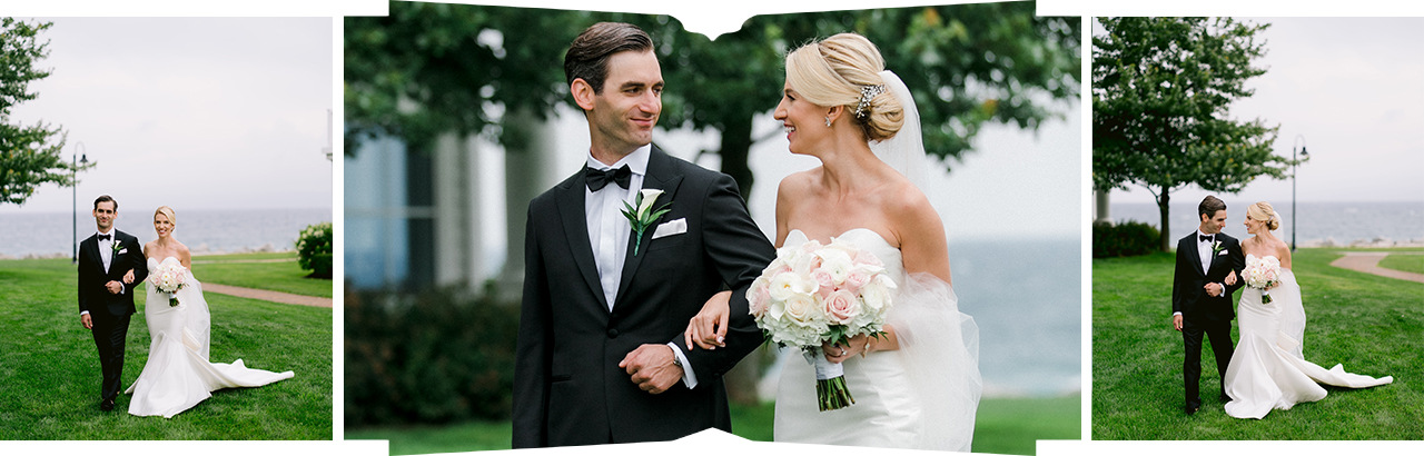 Portraits of a bride and groom walking through green grass with Lake Michigan behind them