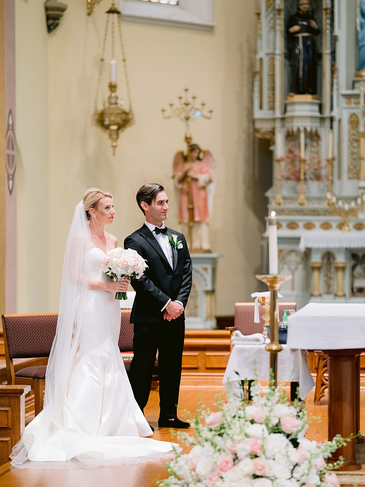 A bride and groom stand together in a cathedral in Northern Michigan