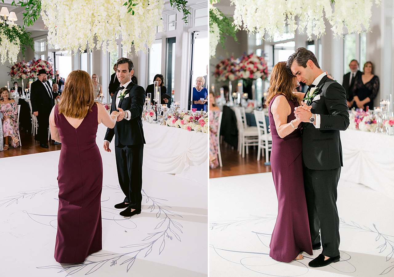 A groom dancing with his mother under a ceiling of florals in Charlevoix, Michigan