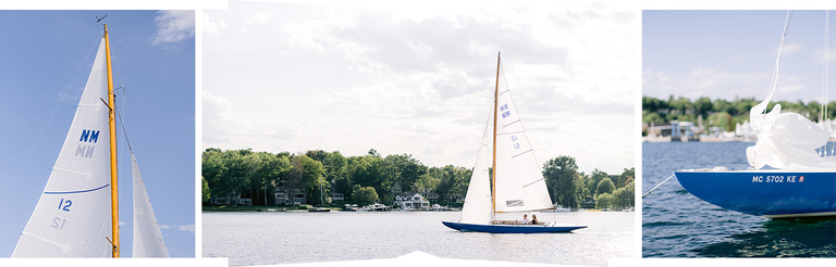 A blue sailboat with white sails sailing in Northern Michigan