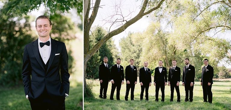 A groom taking portraits in a sunny, grassy field with his groomsmen