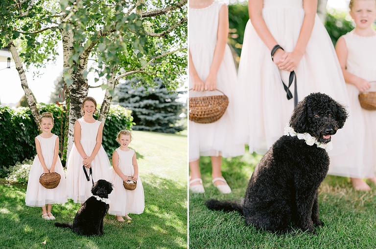 Three flower girls taking portraits with a small black dog