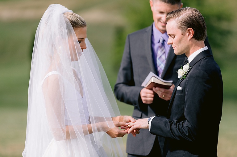 A bride and groom exchanging vows and rings