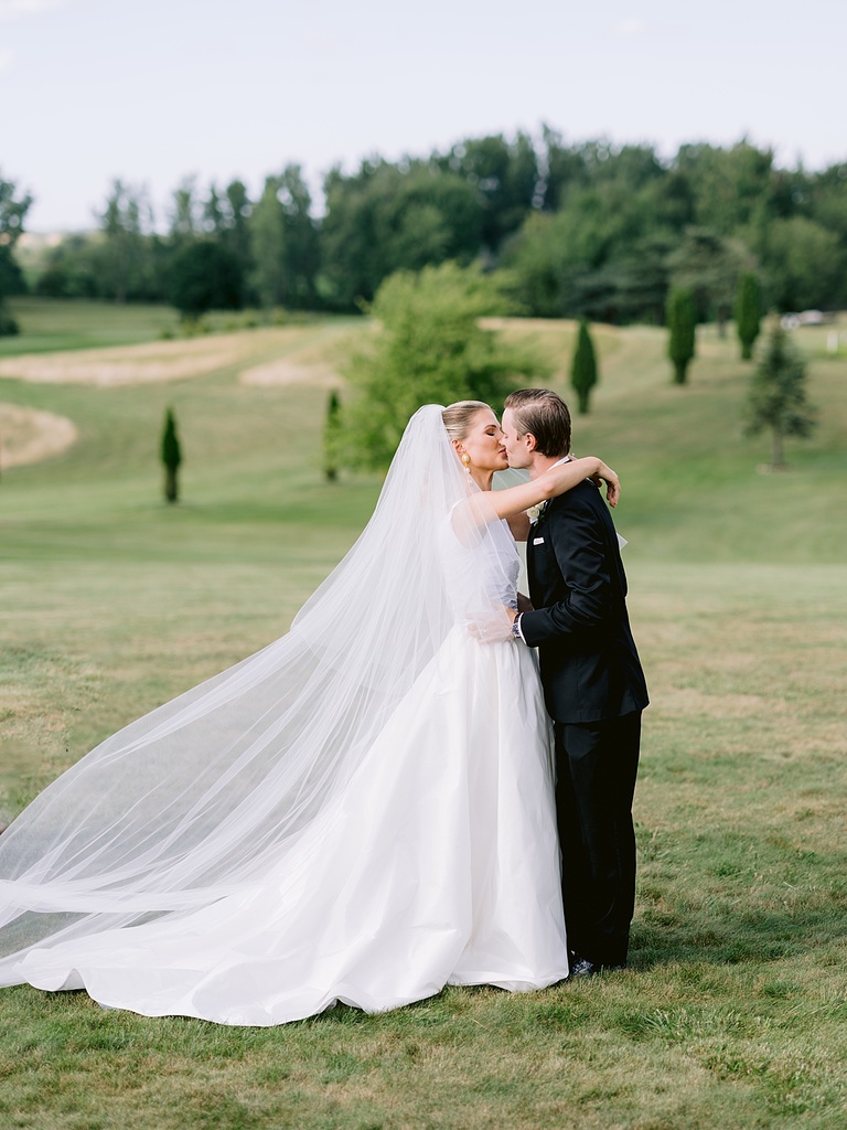 A bride and groom sharing their first kiss on their wedding day in Michigan