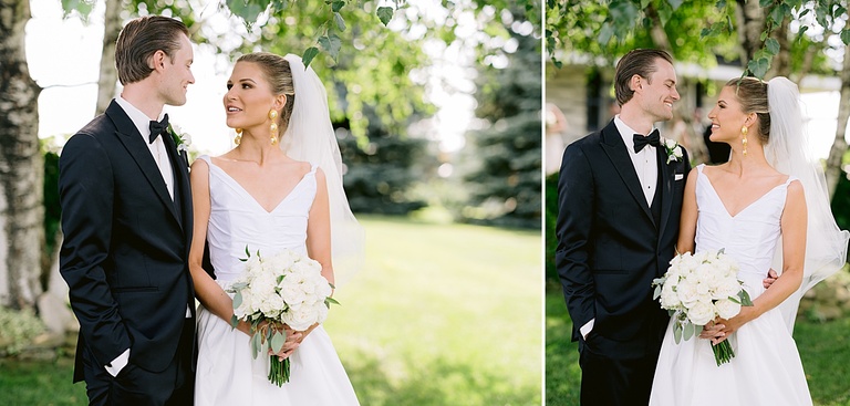 A bride and groom smiling at each other while taking portraits in the country