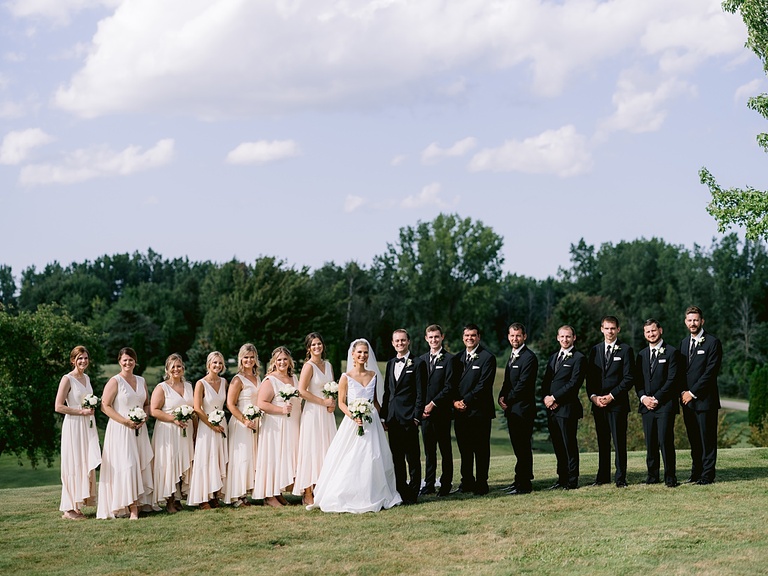 A wedding party portrait on a sunny day in the country in Michigan