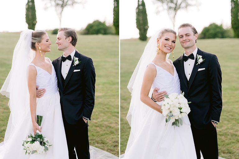 A bride and groom smiling and taking portraits in a grassy field