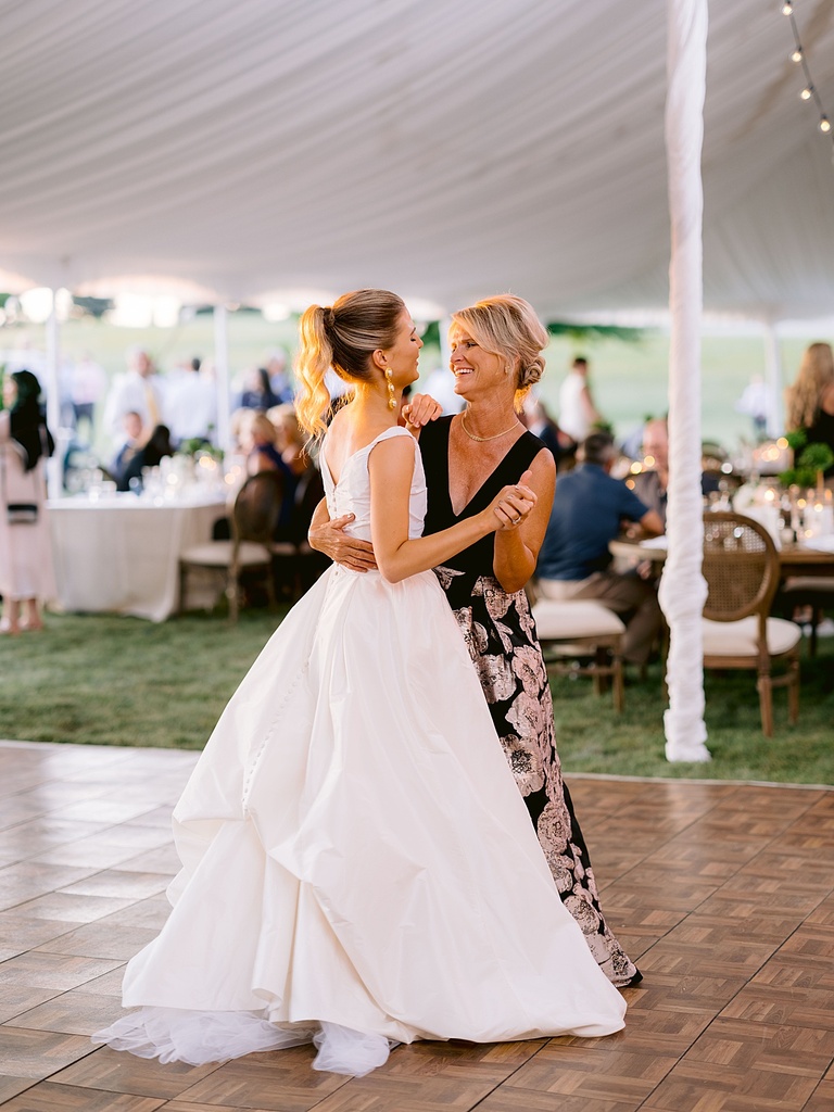 A bride dancing with her mother