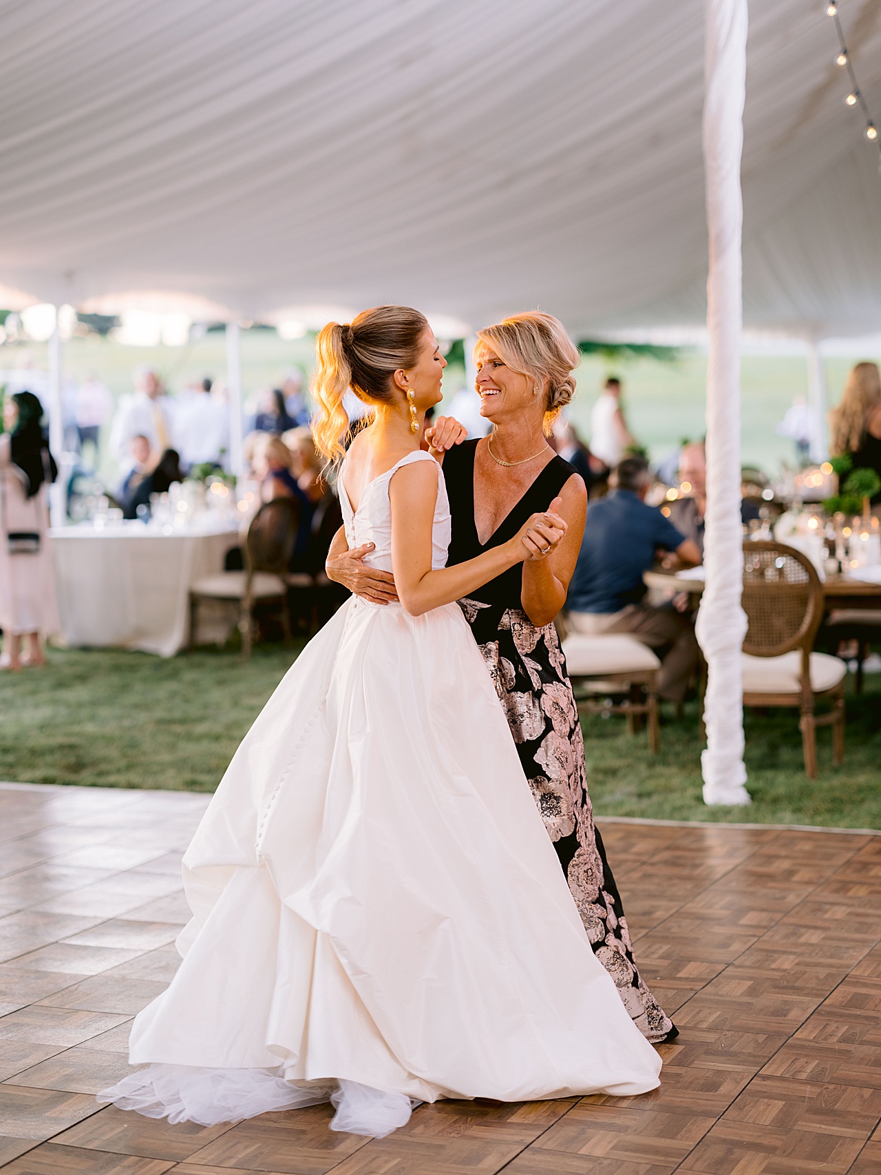 A bride dancing with her mother