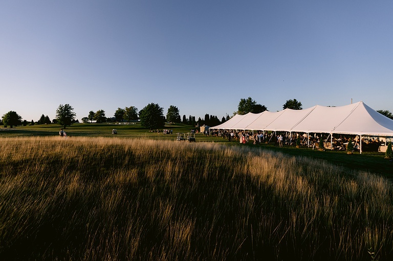 A tented wedding reception in lower Michigan at sunset