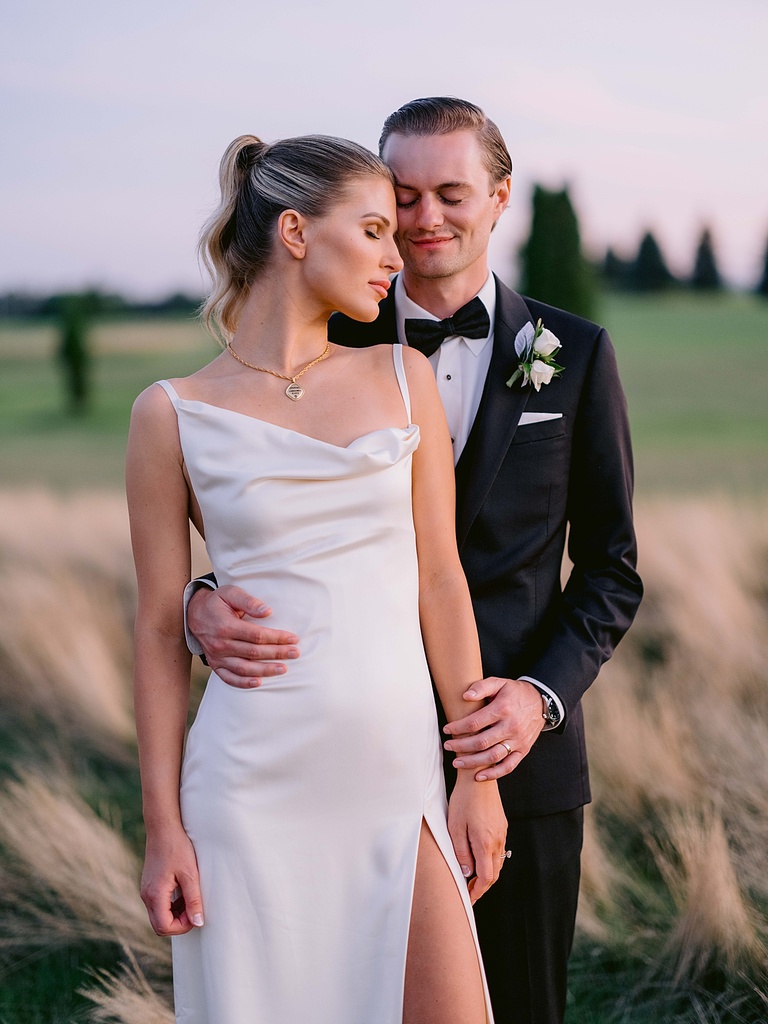 A bride and groom resting their heads together with their eyes closed in Michigan