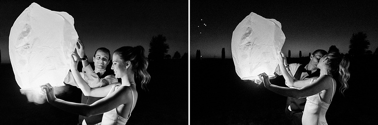 A bride and groom kissing before sending off a lantern