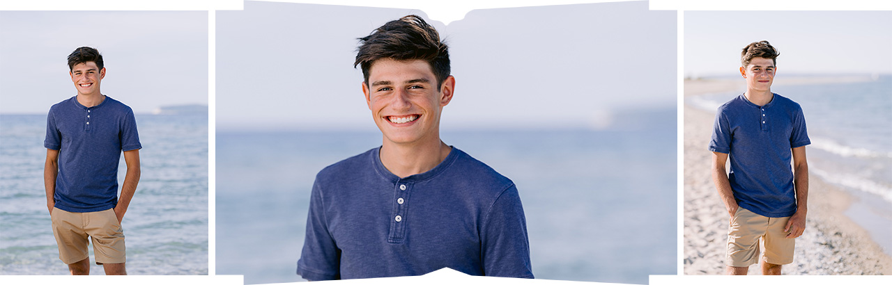 A young man poses in the sunshine on a beach on Lake Michigan for senior photos