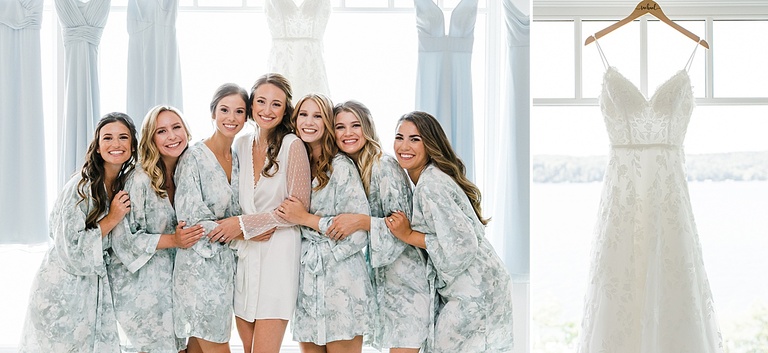 A bride and her bridesmaids in their pastel floral green robes getting into their dresses