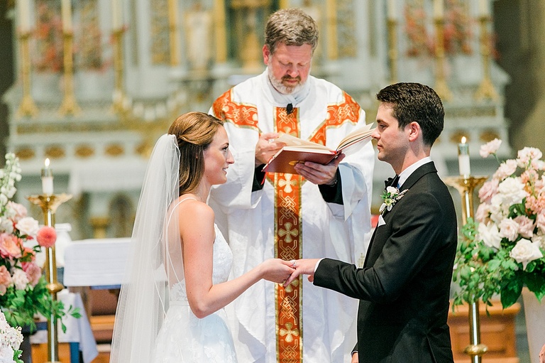 A bride and groom exchanging vows in a Catholic Church in Petoskey, Michigan