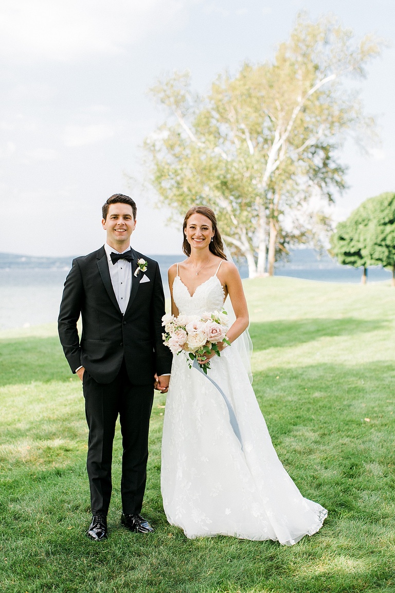 A bride and groom taking wedding portraits at the Bayfront Park in Petoskey