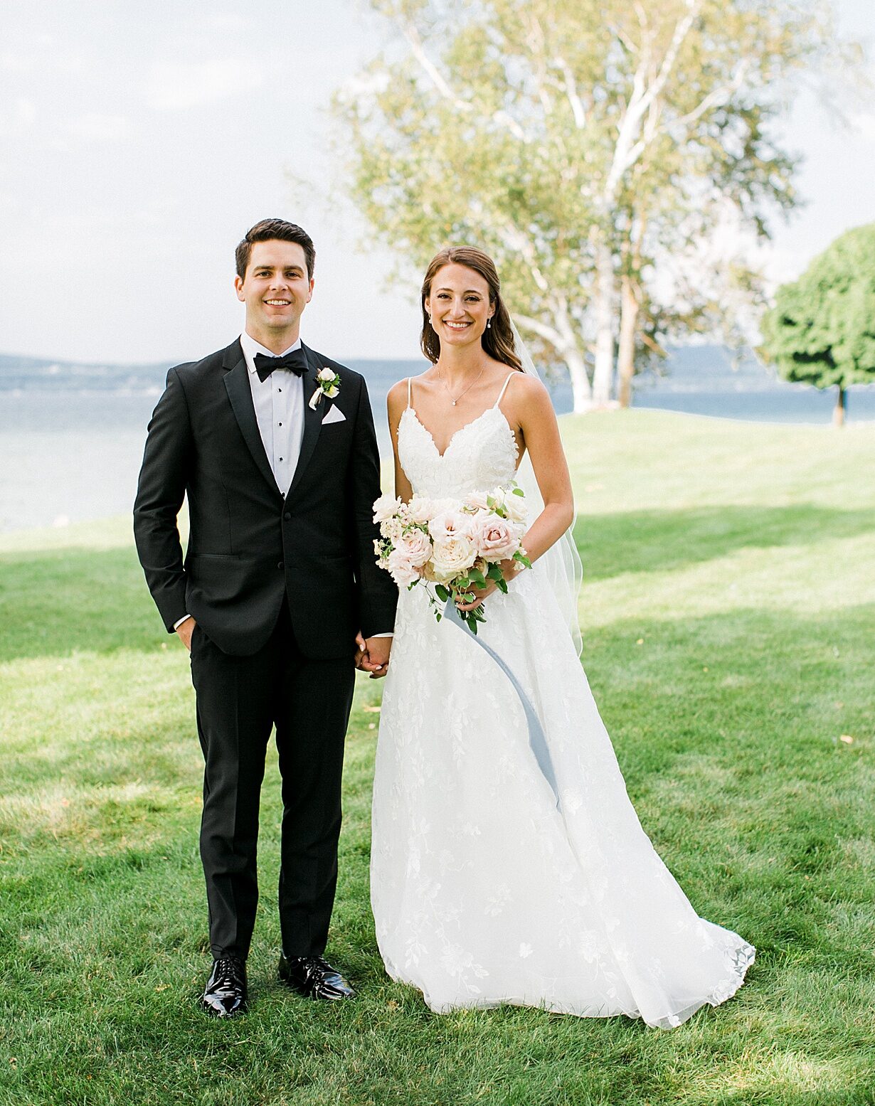 A bride and groom taking wedding portraits at the Bayfront Park in Petoskey