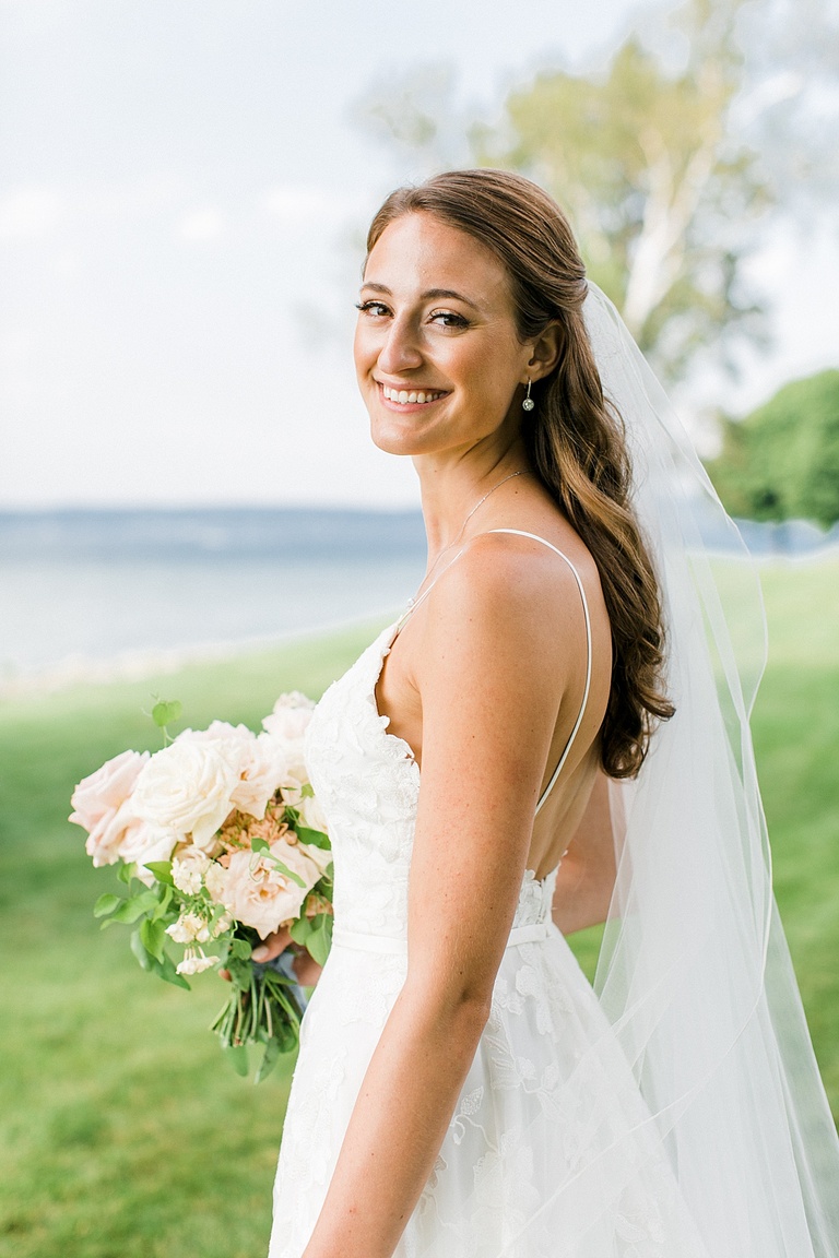 A portrait of a bride smiling near the lake in Northern Michigan