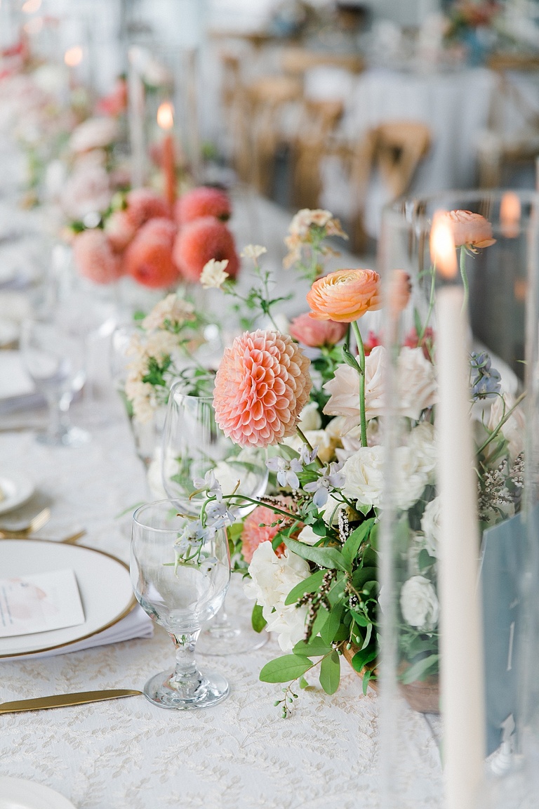 Colorful reception florals with tall white candles at a wedding reception in Northern Michigan
