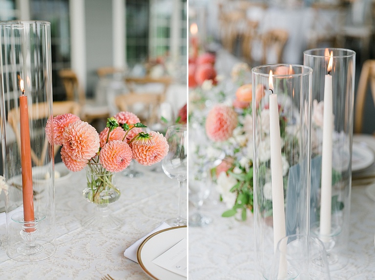 Tall white candles burning with bright pink flowers